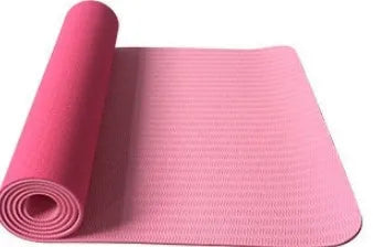 6mm TPE beginner yoga mat in black, rolled on wooden floor with textured non-slip surface visible