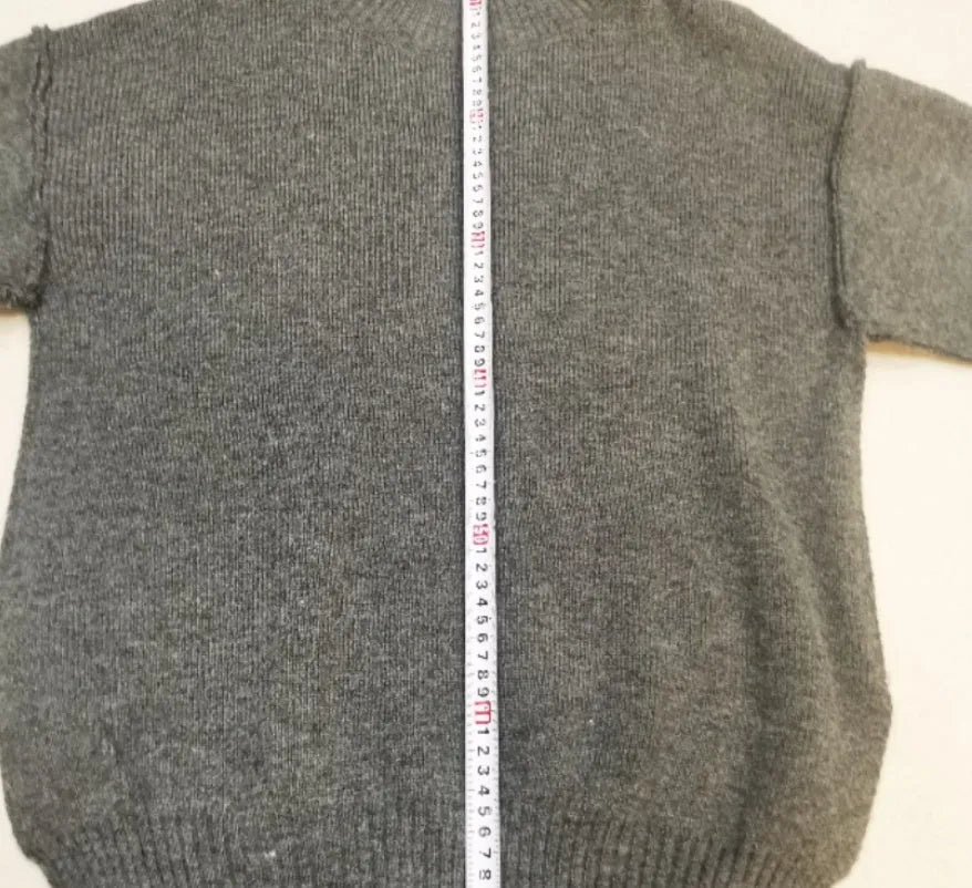 Women's dark grey casual suit with side-slit sweater top and matching trousers.