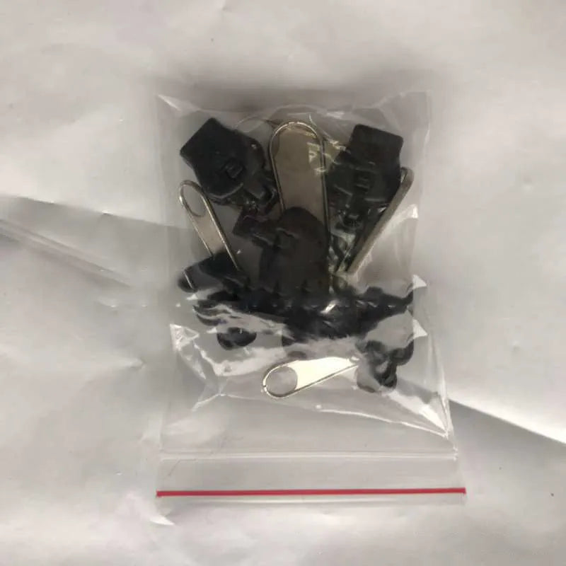 Reusable zipper head repair kit with 12 plastic and metal sliders in black, black grey, and coffee brown colours