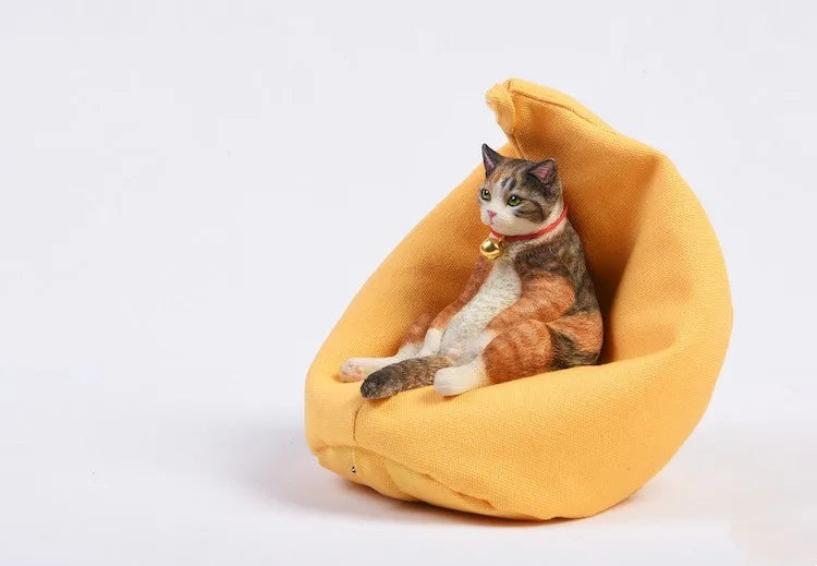 Small lazy cat car ornament with fabric sofa, 75mm high dashboard decoration.