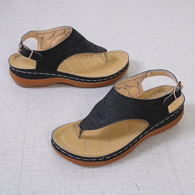 Women's red casual wedge heel sandals with an adjustable buckle strap on a white background.