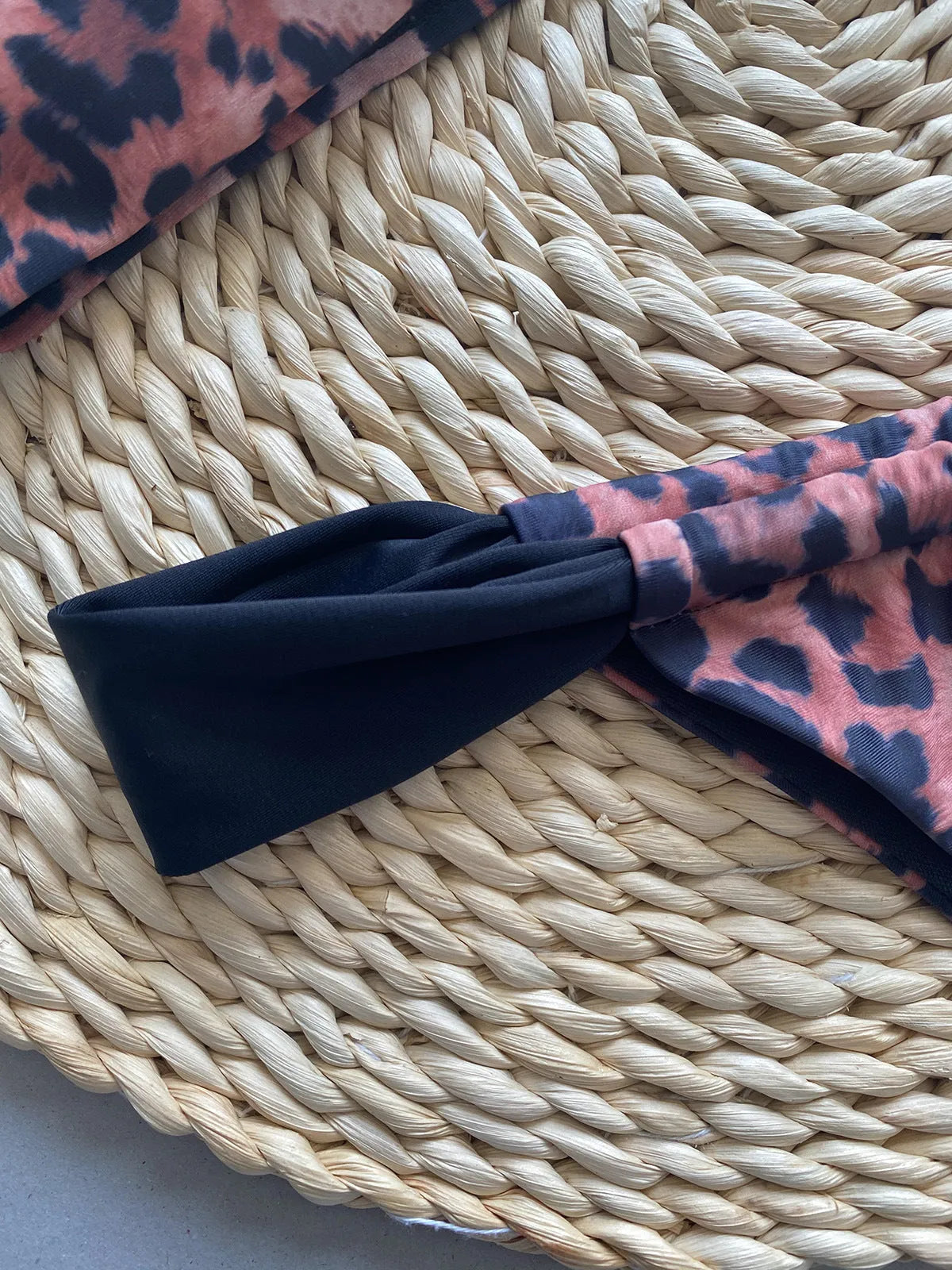 Women's leopard print bikini set with sleeveless tube top and matching swimsuit bottoms.
