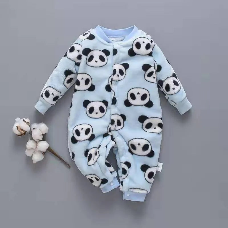 Baby wearing a long-sleeved flannel romper in a pink bunny head print, showcasing the 100% cotton fabric.