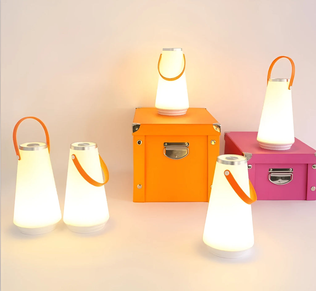 White rechargeable LED lantern night light on a wooden bedside table.