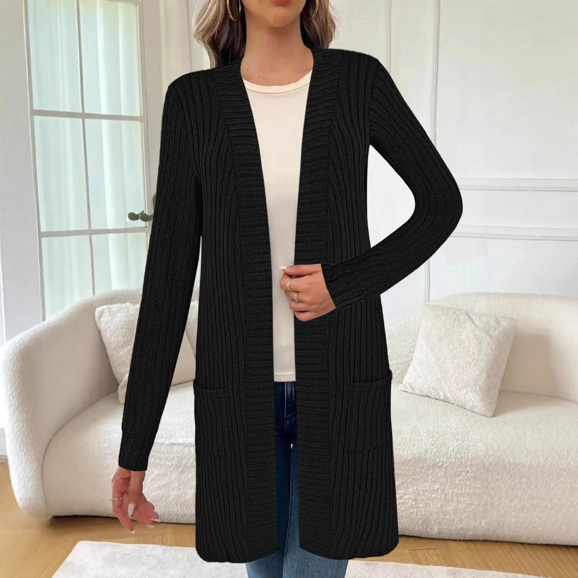 Women's plus size black knitted cardigan jacket with long sleeves and front pockets.