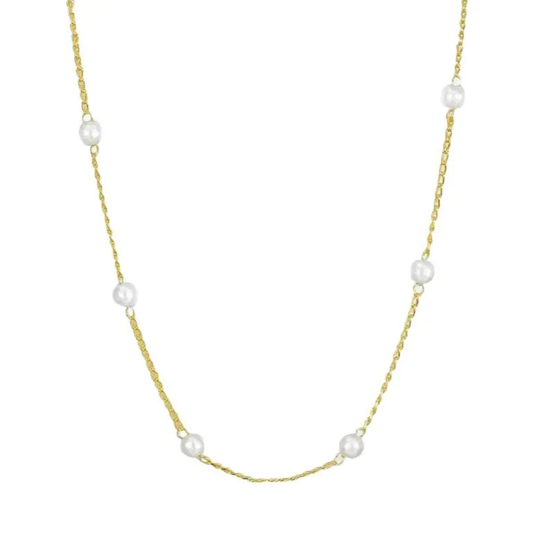 Pearl necklace with copper geometric pendant and ball bead chain on dark background