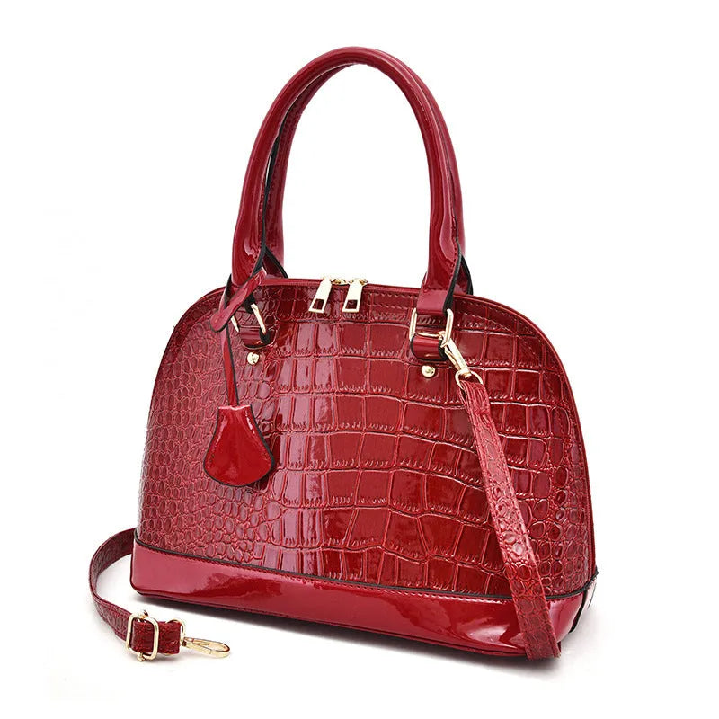 Shiny PU leather crossbody shoulder bag with shell-shaped design in black, red, or brown
