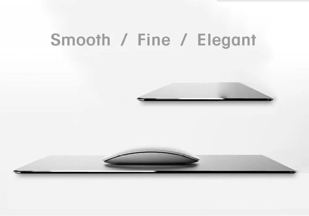 Black aluminium alloy double-sided mouse pad on a desk with a computer mouse on top
