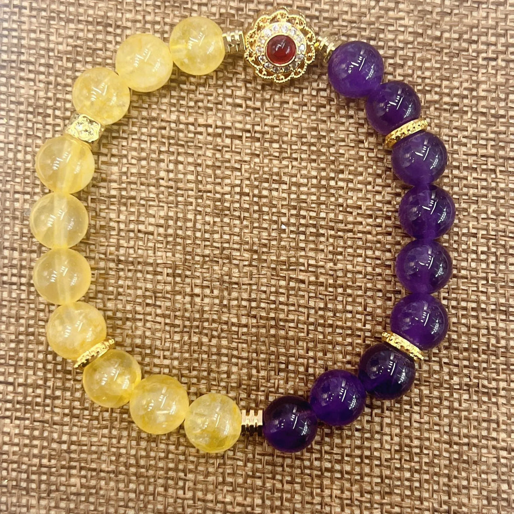 Handmade women's bracelet with yellow and purple amethyst crystals on wrist