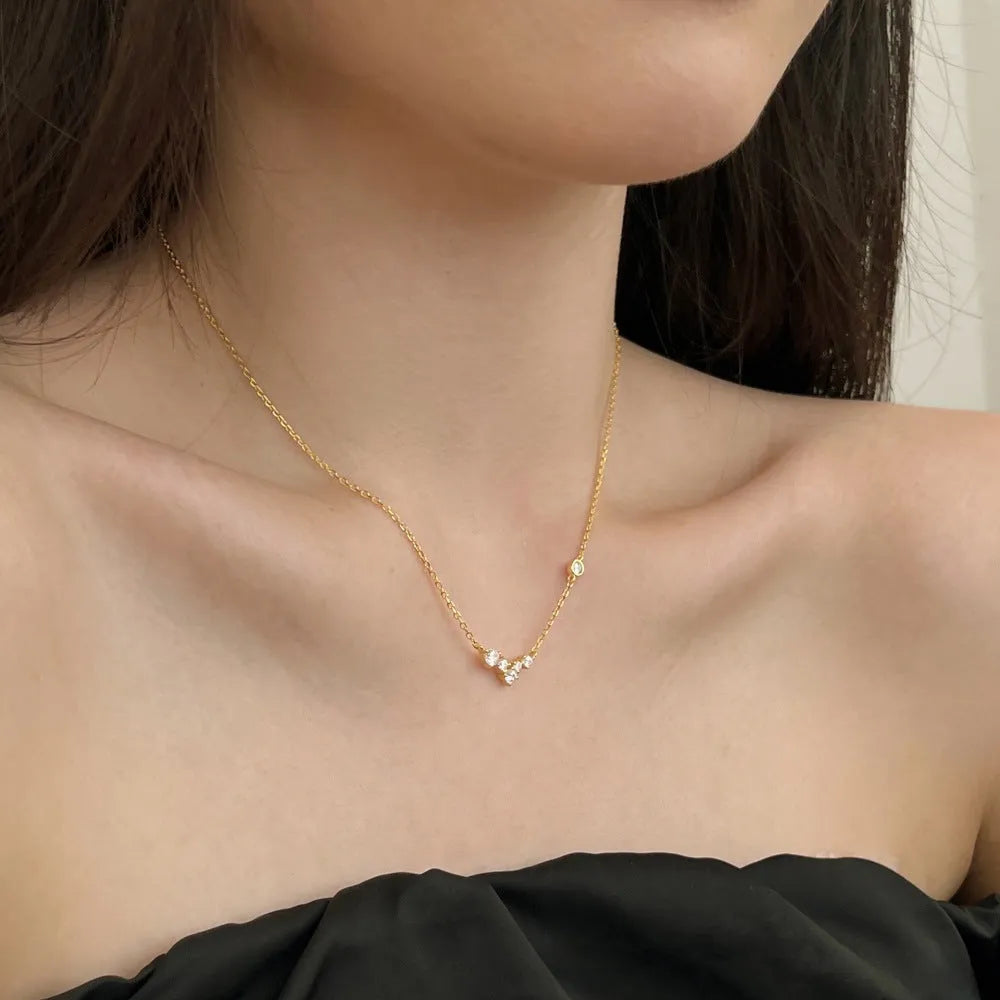 925 silver clavicle chain necklace with geometric pendant in electroplated gold finish on a woman's neck