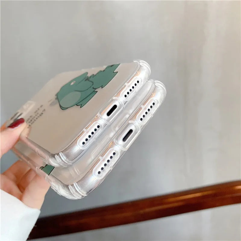 Clear transparent iPhone case with green dinosaur design showing phone protection