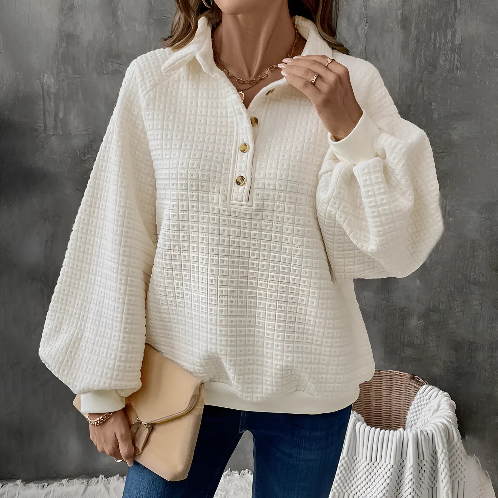 Women's beige thick polo collar long sleeve sweater laid flat.
