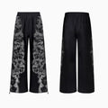 Loose-fit printed polyester streetwear co-ord set showing trousers, seven-inch shorts, and a hoodie on a hanger.
