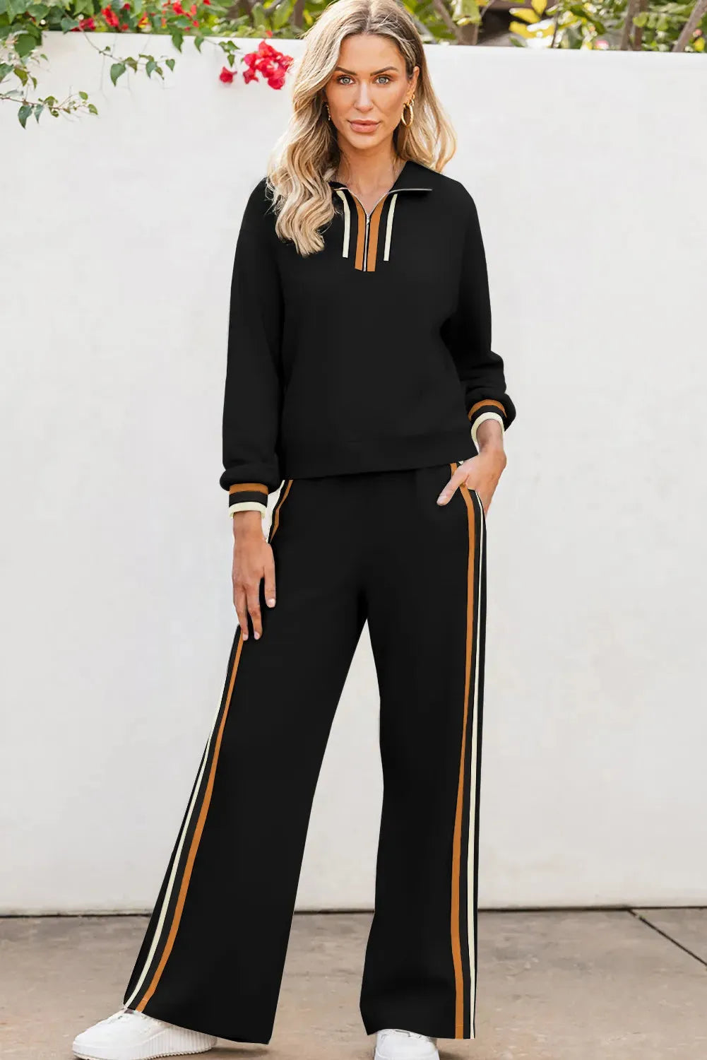 Black striped patchwork quarter zip pullover and loose pant set on a model, showing loose fit and striped detailing.