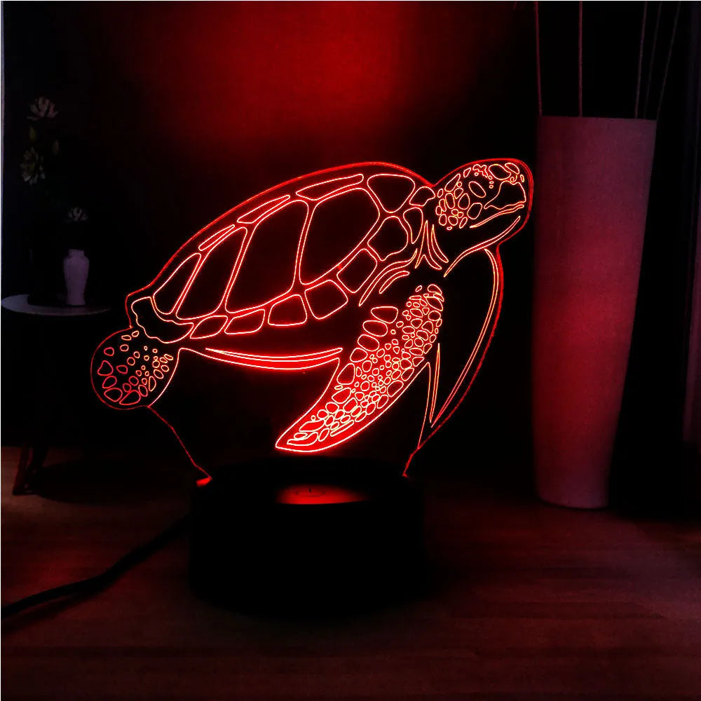 3D acrylic turtle-shaped LED night light glowing in blue, with a remote control.