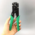 Green dual-purpose crystal head net pliers with tool steel jaws and plastic handle on plain background