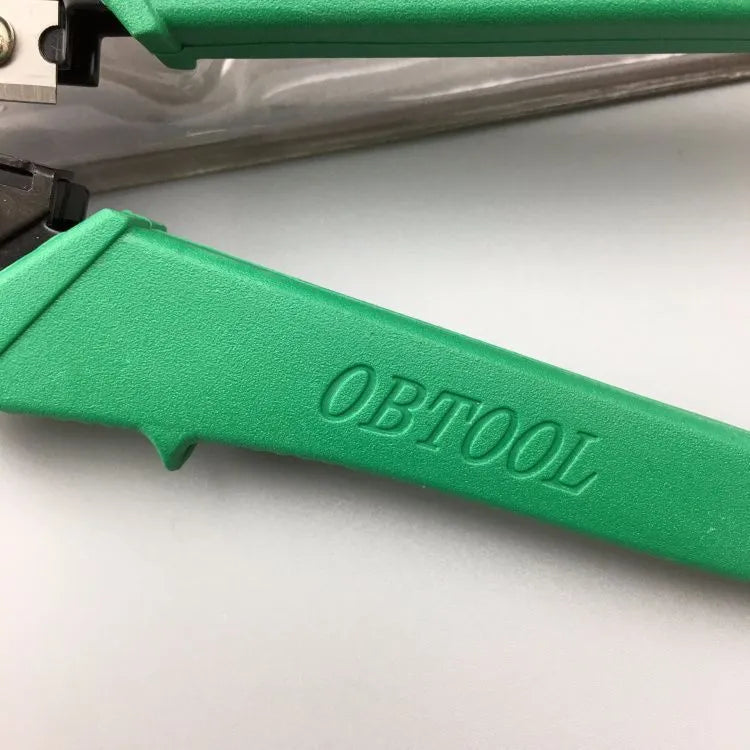 Green dual-purpose crystal head net pliers with tool steel jaws and plastic handle on plain background