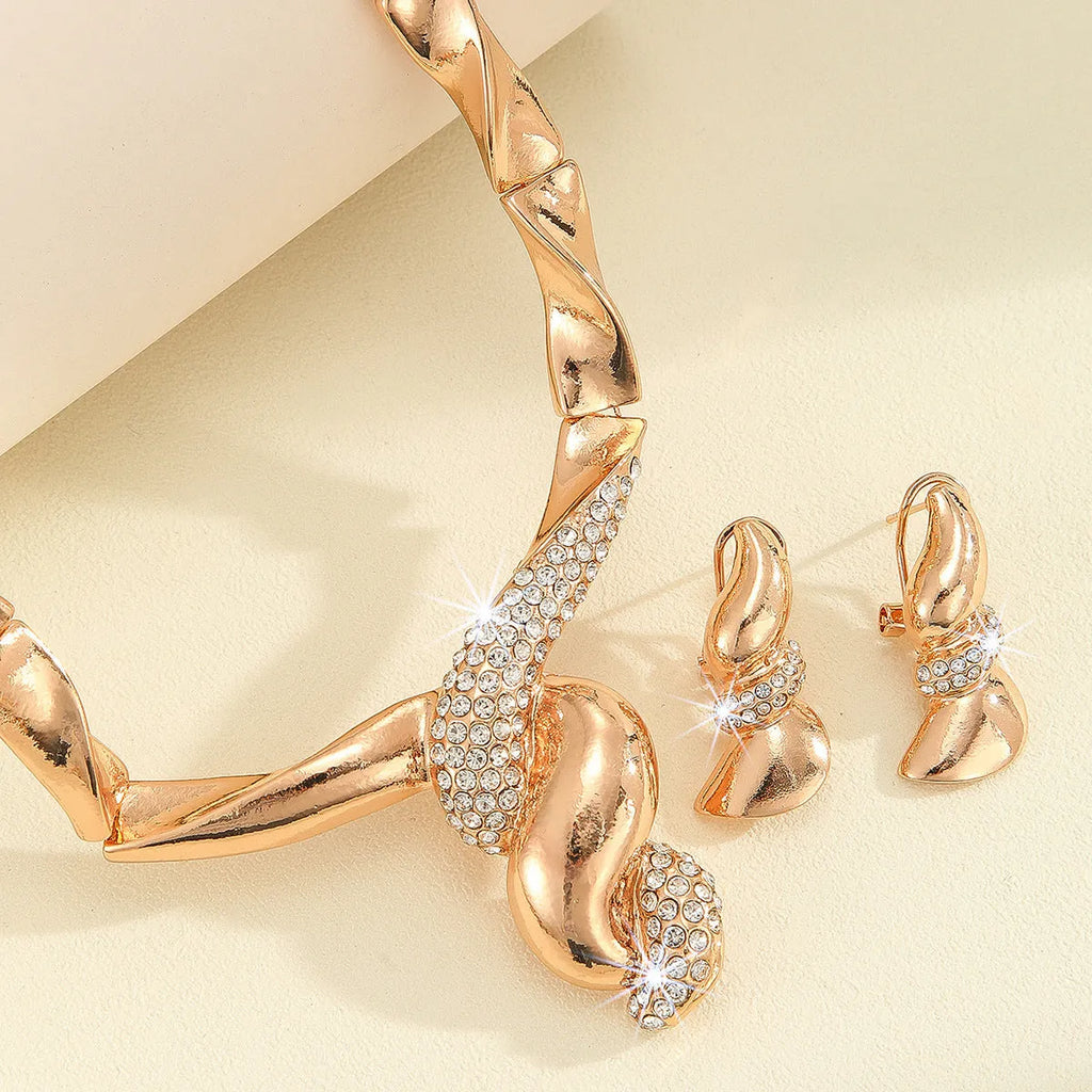 Gold alloy thread necklace and earrings suite with love heart pattern on a white background