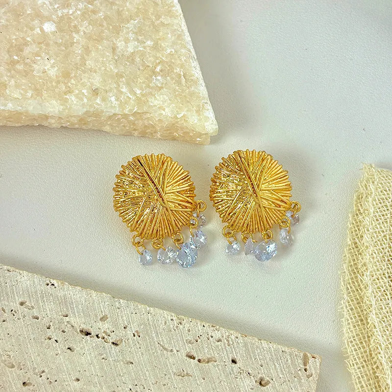 Women's gold geometric hoop earrings with round elements and electroplated finish