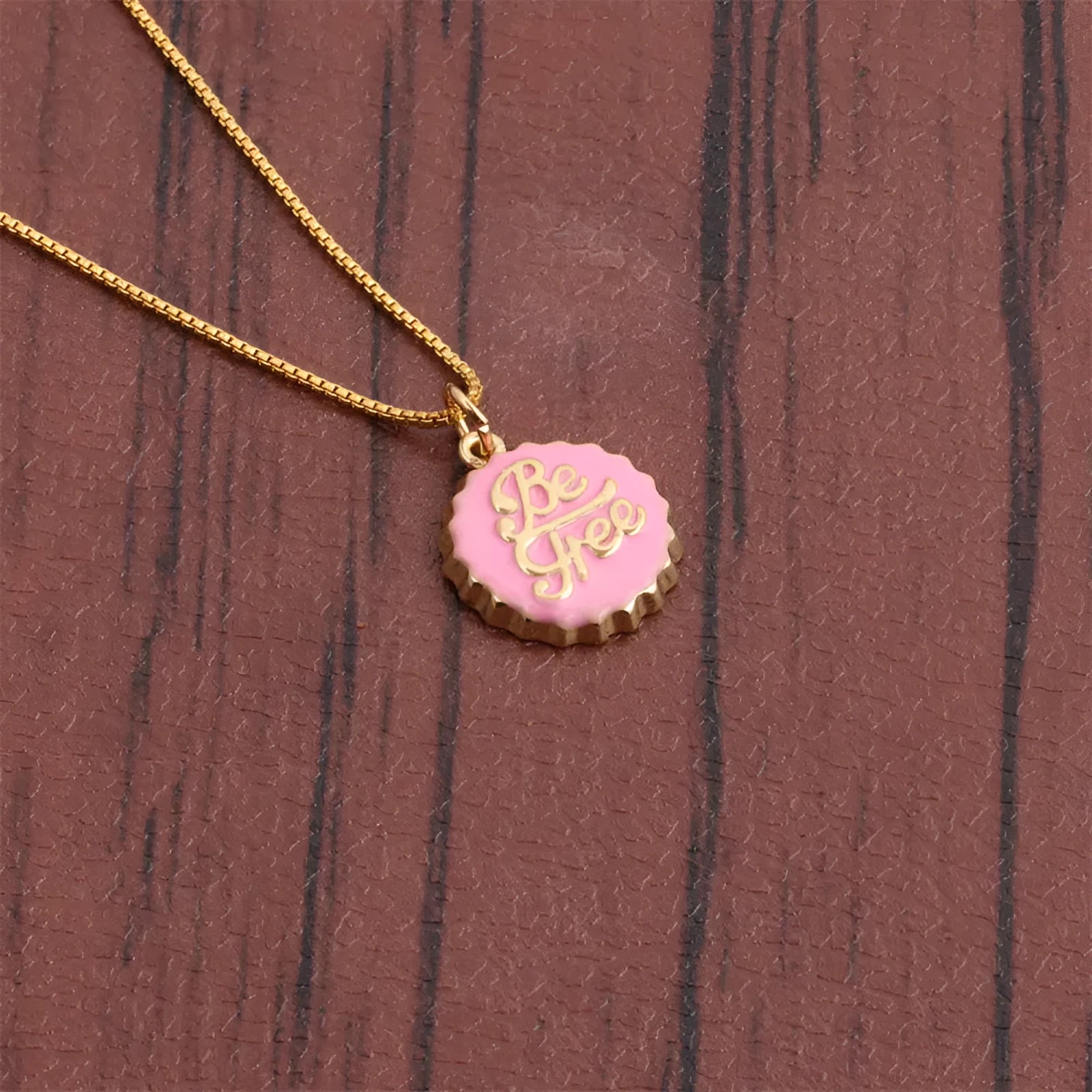Copper bottle cap pendant necklace with gold-colour electroplated finish on a 40cm box chain.