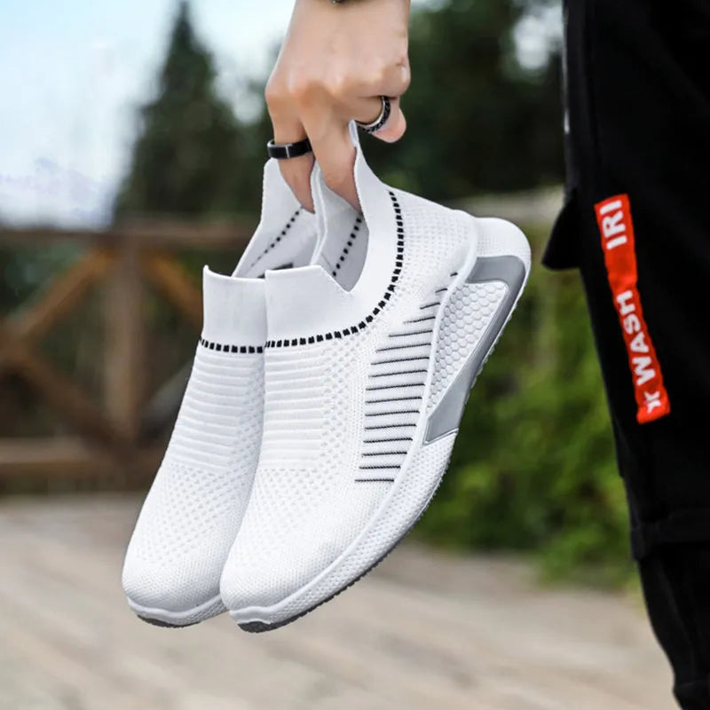 Men's black and white striped mesh slip-on sneakers with flyknit upper and low-cut profile.