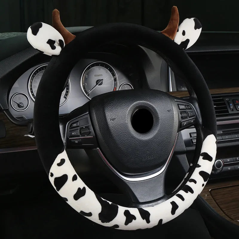 Short plush steering wheel cover with protective handle section in black colour
