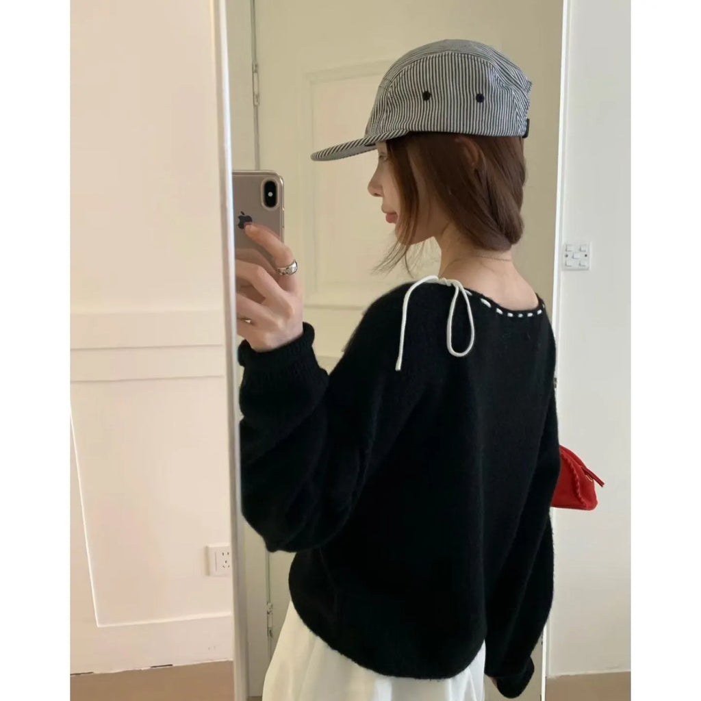 Women's loose-fitting black knitwear pullover jumper made from regenerated cellulose fibre.