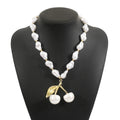 Gold and pearl fruit geometric necklace for women on a white background