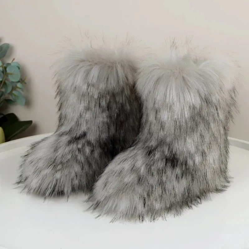 Women's mid-calf faux fur winter boots with flat heel and plush lining, shown in imitation raccoon fur khaki