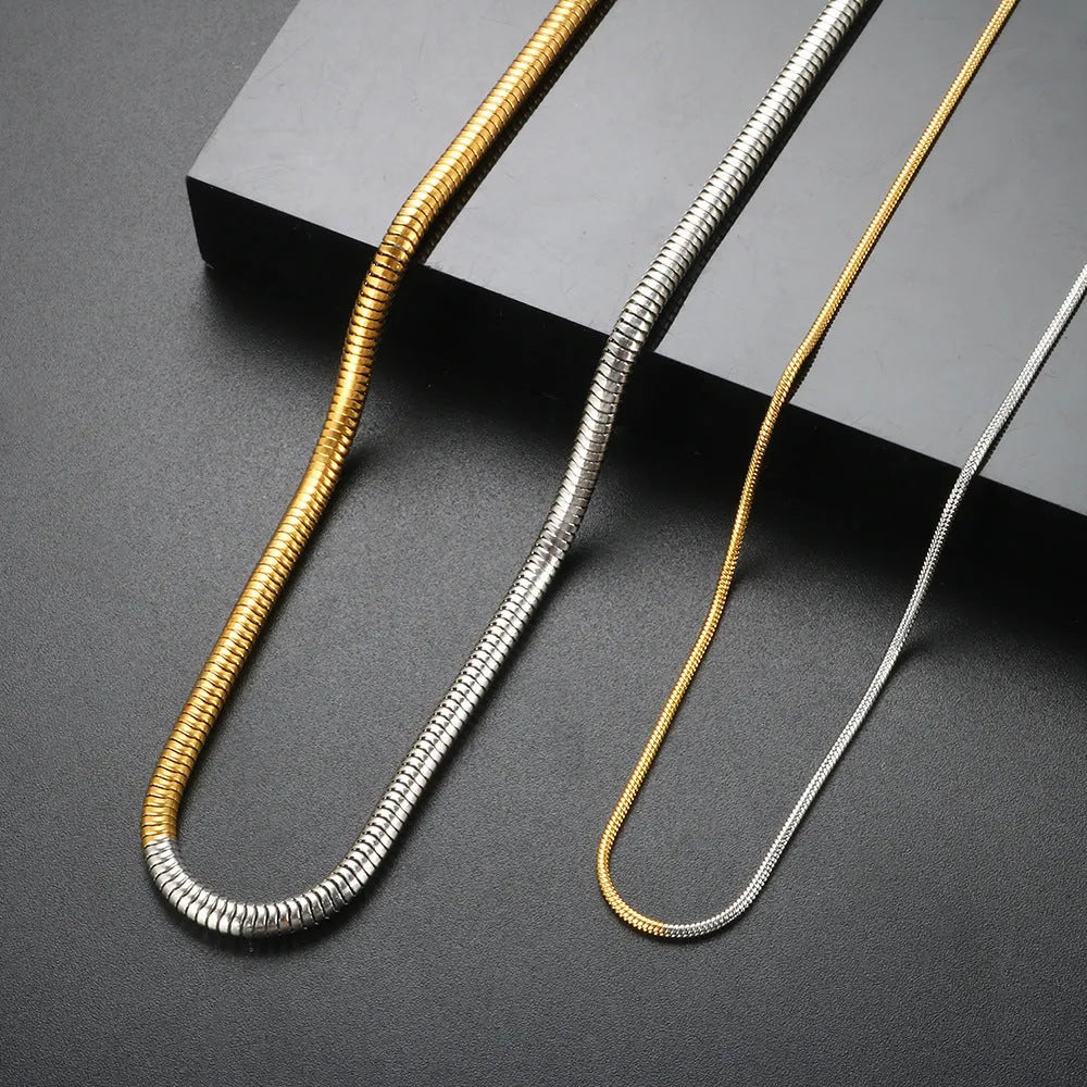 Gold-coloured stainless steel snake bone chain necklace with geometric design, 3mm width.