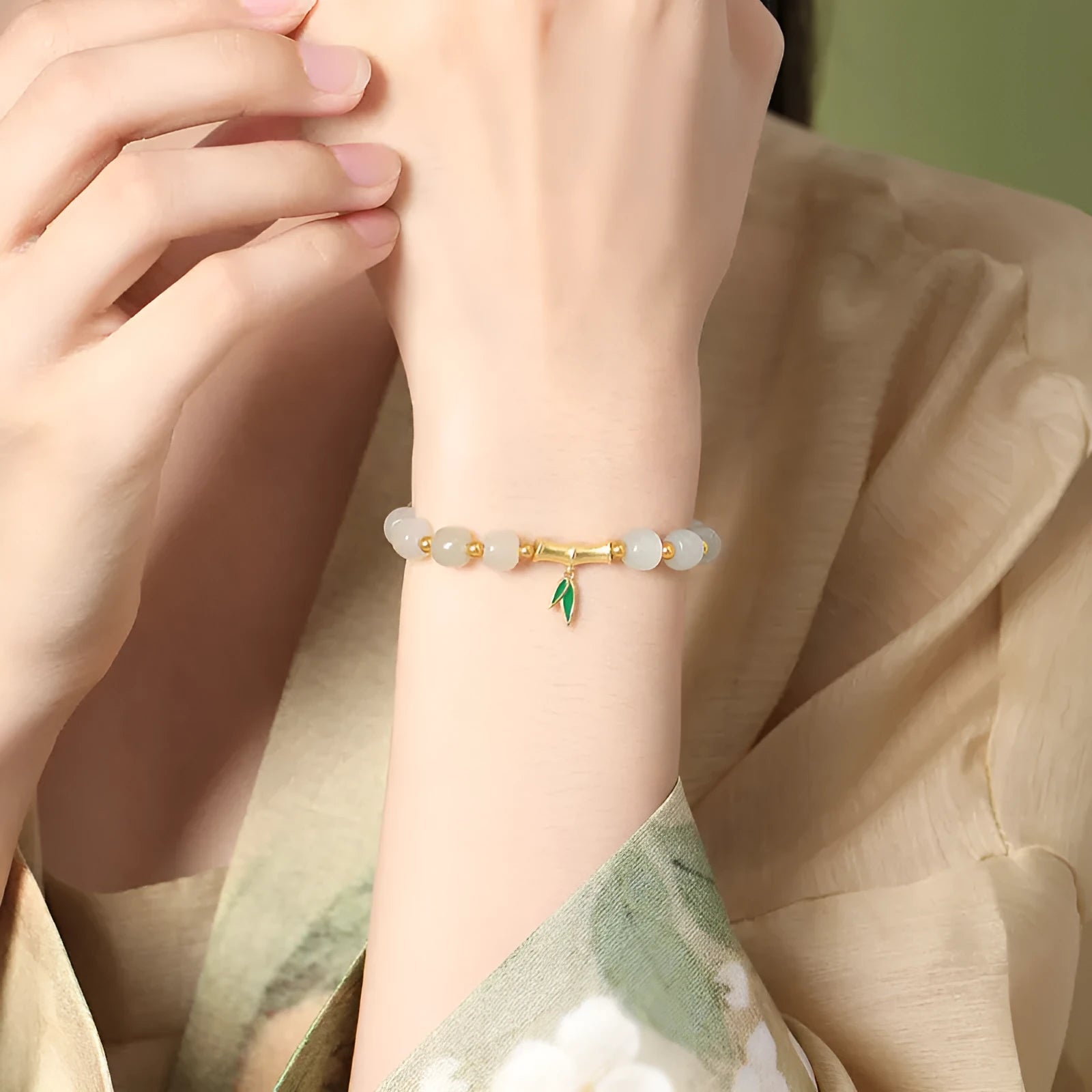 S925 sterling silver bracelet with round Hetian jade beads and bamboo leaf charms.