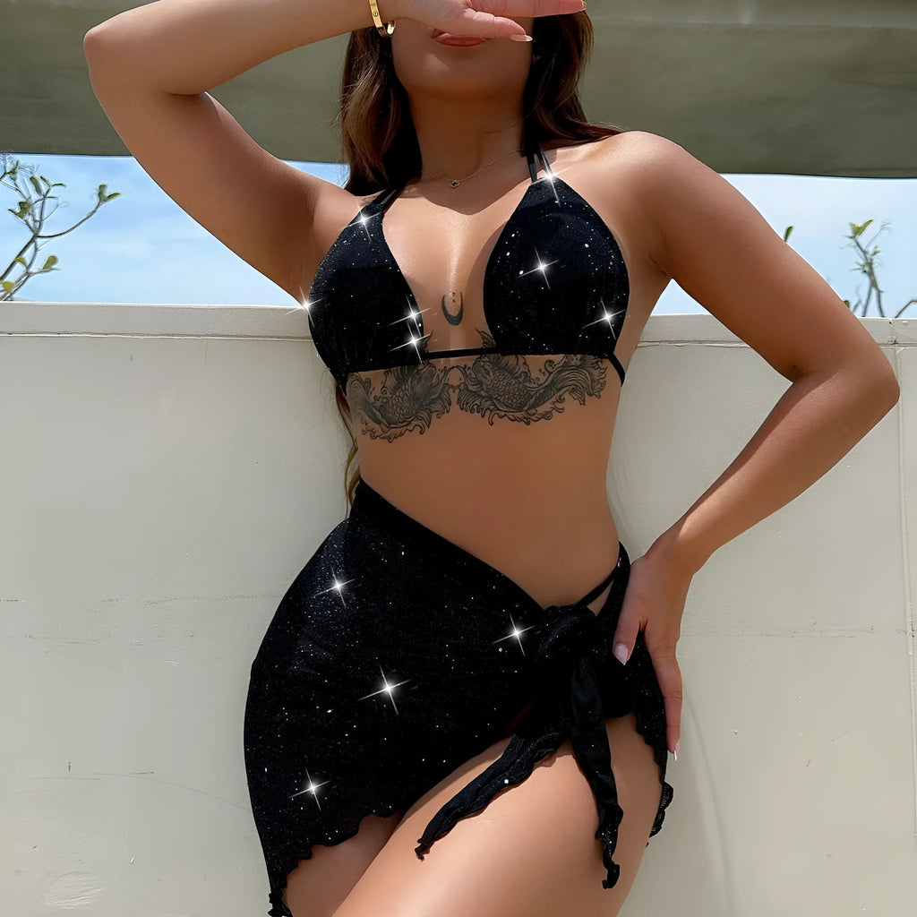 Black three-piece bikini swimsuit set with top and shorts on a plain background.