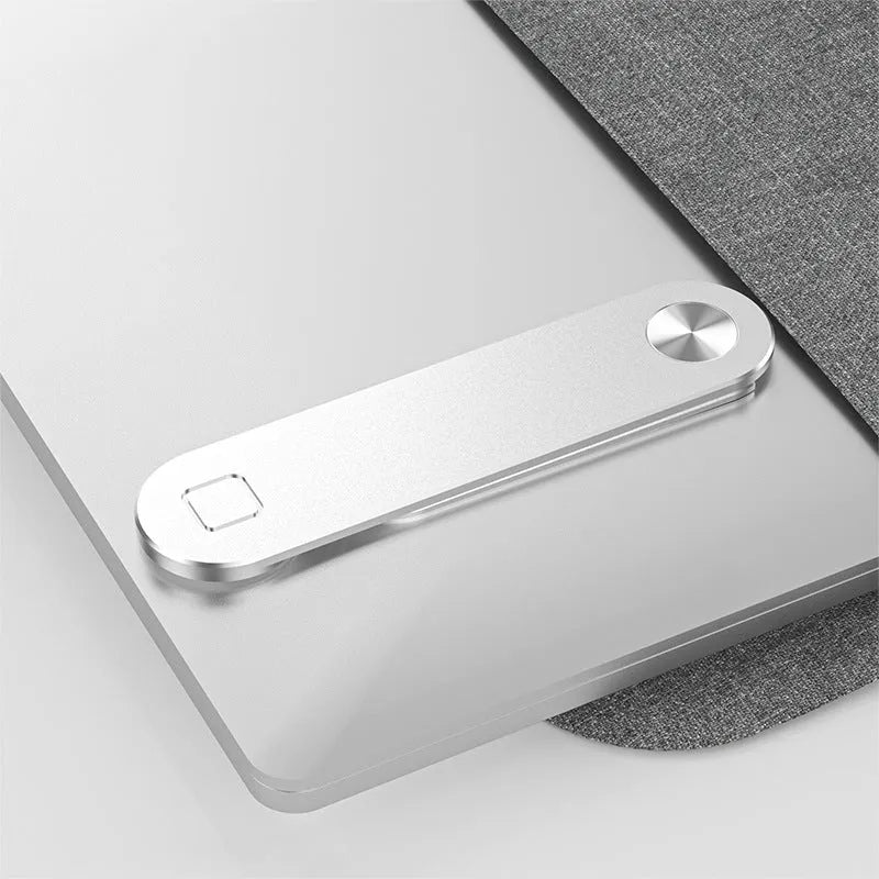Black aluminium laptop phone holder with magnetic clip attached to laptop edge holding a smartphone
