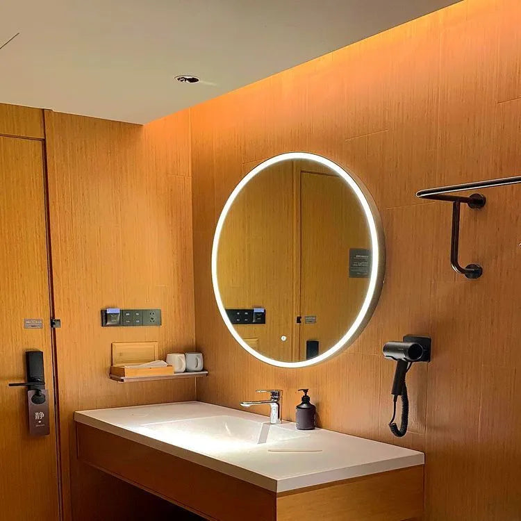 Round black framed LED bathroom mirror mounted on wall with dimmable lights.