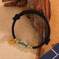 Silver geometric bracelet with peace buckle and integrated carrying strap in black colour