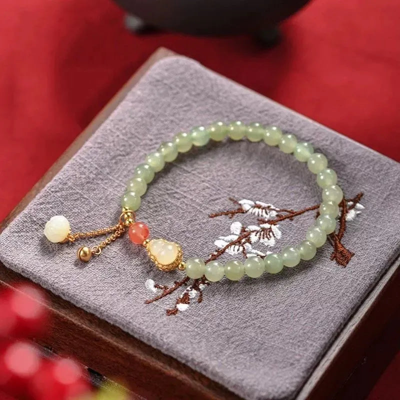 Jade women's bracelet with gold-plated gourd charm and fu character traditional design elements