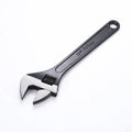 10-inch black high carbon steel adjustable open-end wrench on a workbench