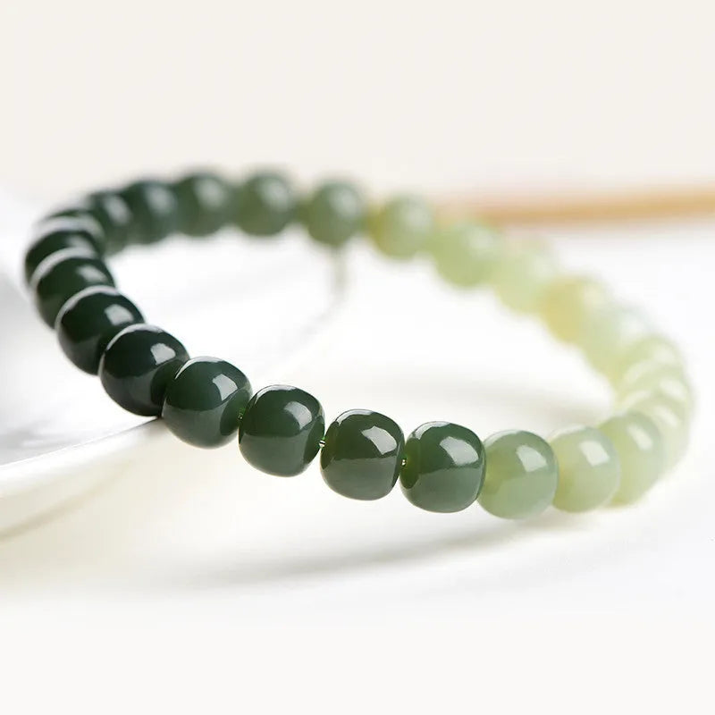 Polished Hetian jade bracelet with clear water gradient colour on wrist.