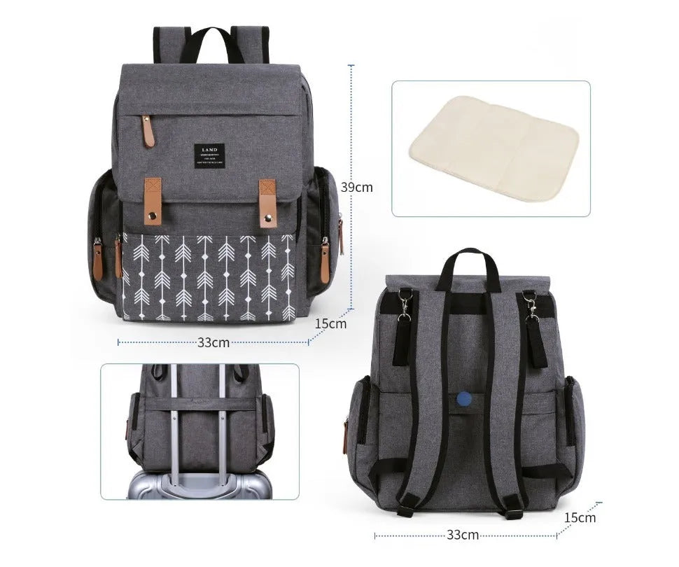 LAND Mommy large grey Oxford cloth diaper backpack with changing mat, shown on a table