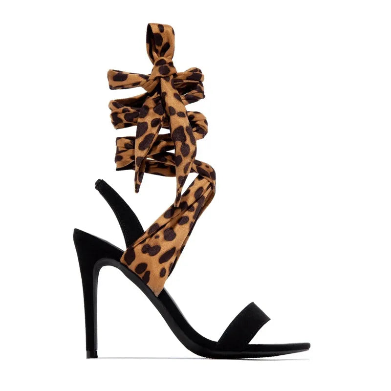 Light brown leopard print women's high heels with cross straps and a fine super high heel.