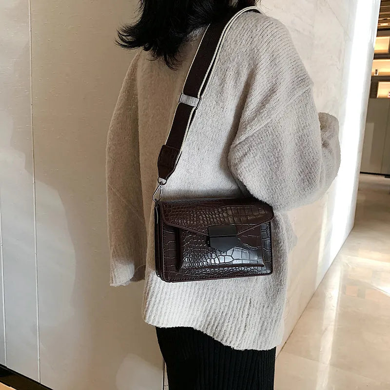 Vintage-style black PU crossbody bag with adjustable strap showing interior