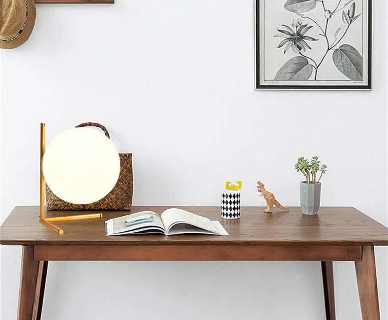 Creative desk lamp with glass shade and three-tone LED light on a desk, showing push button switch and cable.