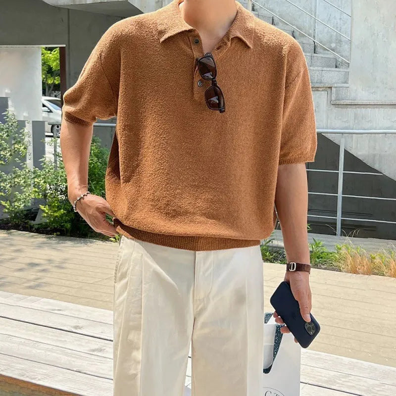 Men's caramel coloured retro knitted polo shirt with short sleeves and an asymmetrical design detail, laid flat.