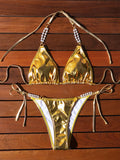 Gold halter lace-up bikini with pearl chain detail and briefs-style bottoms