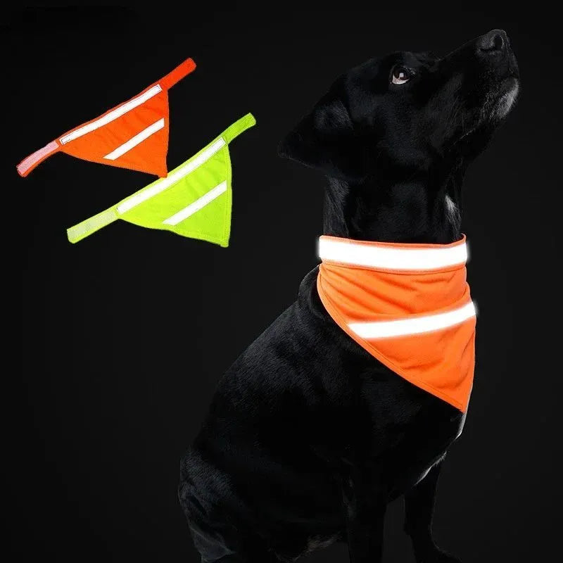Yellow and orange reflective triangular dog bandana with adhesive strap on a dog's neck.