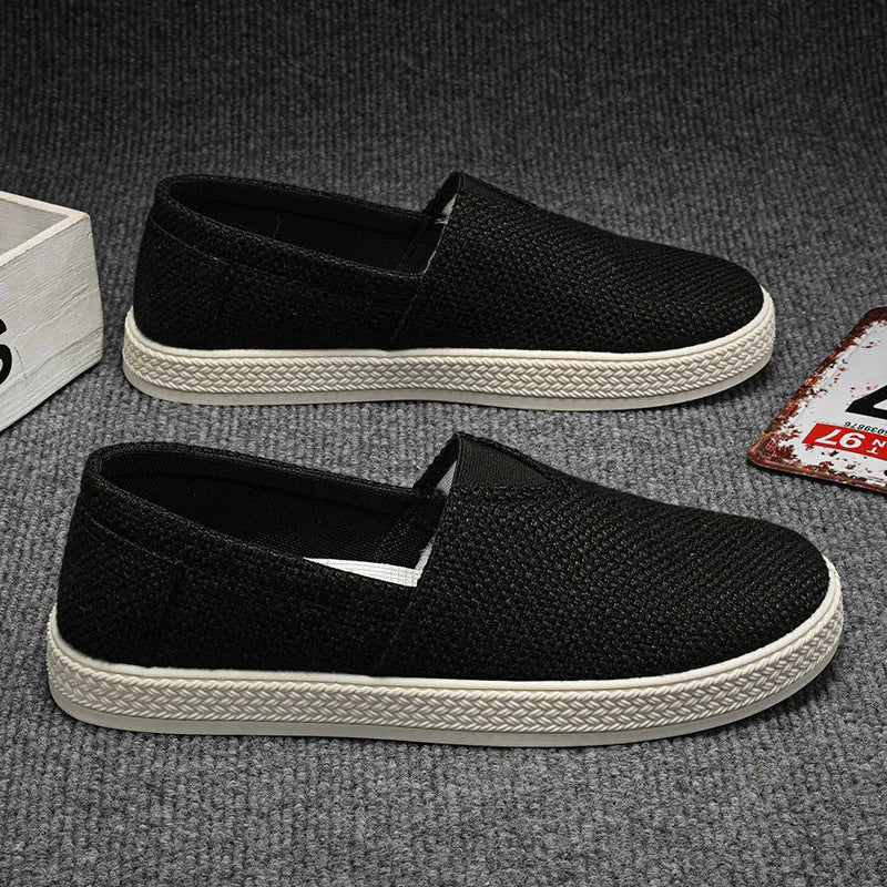 Men's beige linen cloth shoes with canvas upper and PVC sole on a plain background.