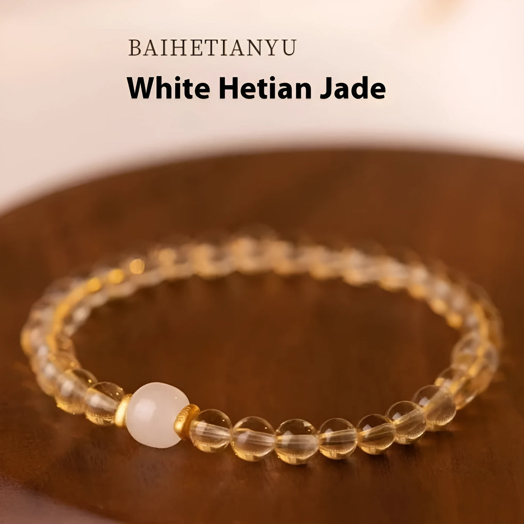 Handmade natural rutilated quartz bracelet with golden needles on wrist, showing 8mm beads.