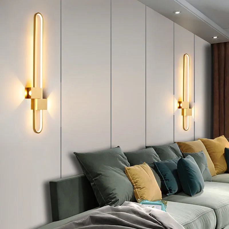 Round minimalist iron wall lamp with warm white LED light in black or gold finish.
