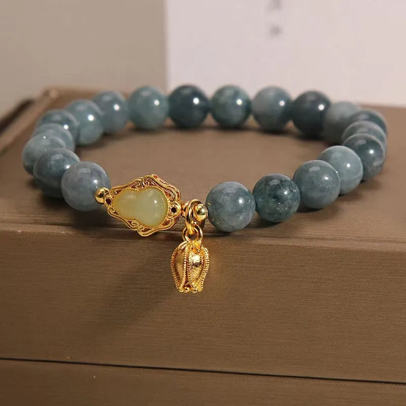 Sky blue natural stone gourd lotus flower pendant on a women's adjustable bracelet with electroplated metal.