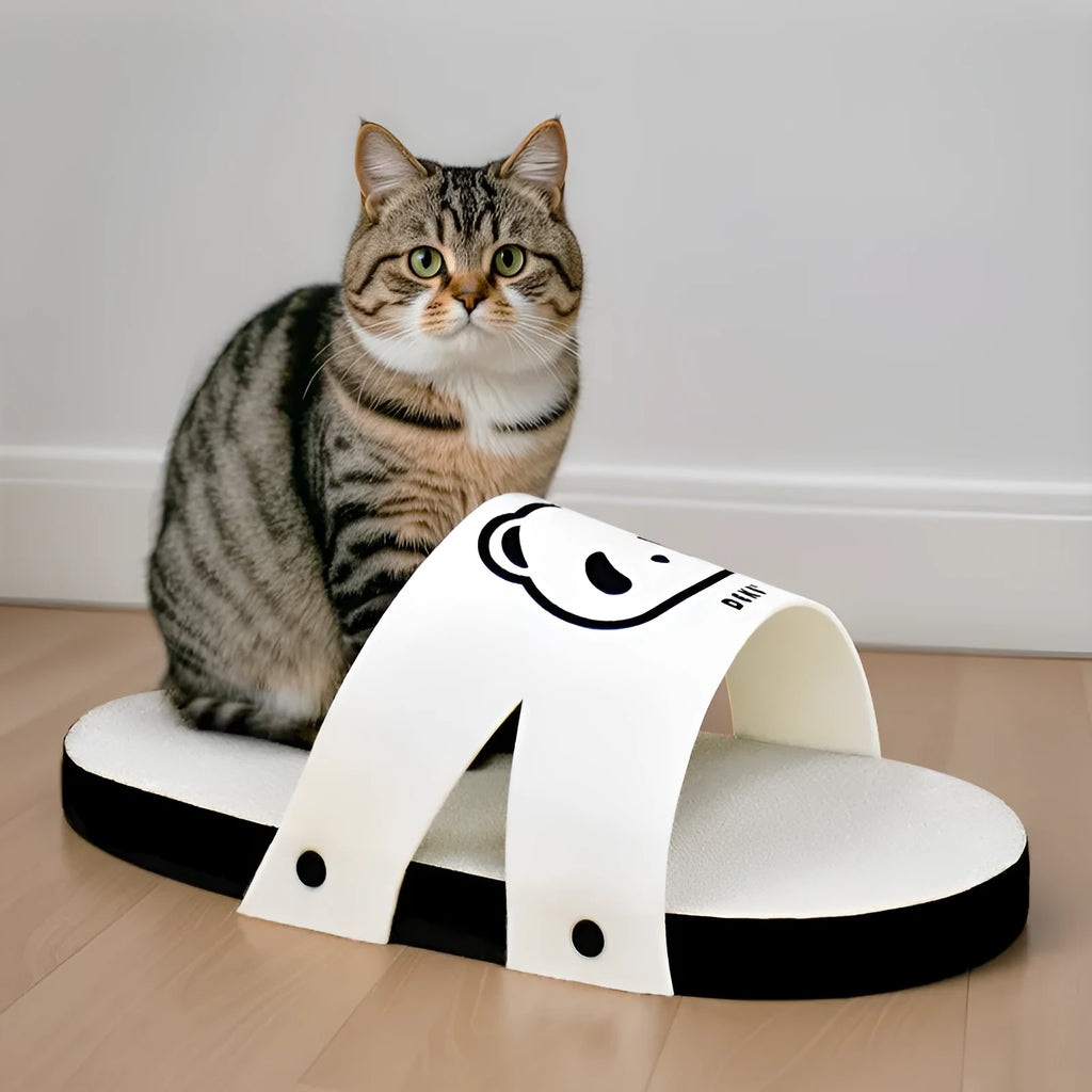 White slipper-style corrugated paper cat scratch board on a floor.